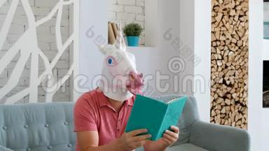 奇怪的<strong>搞笑视频</strong>：戴着独角兽面具的男人坐在沙发上看书